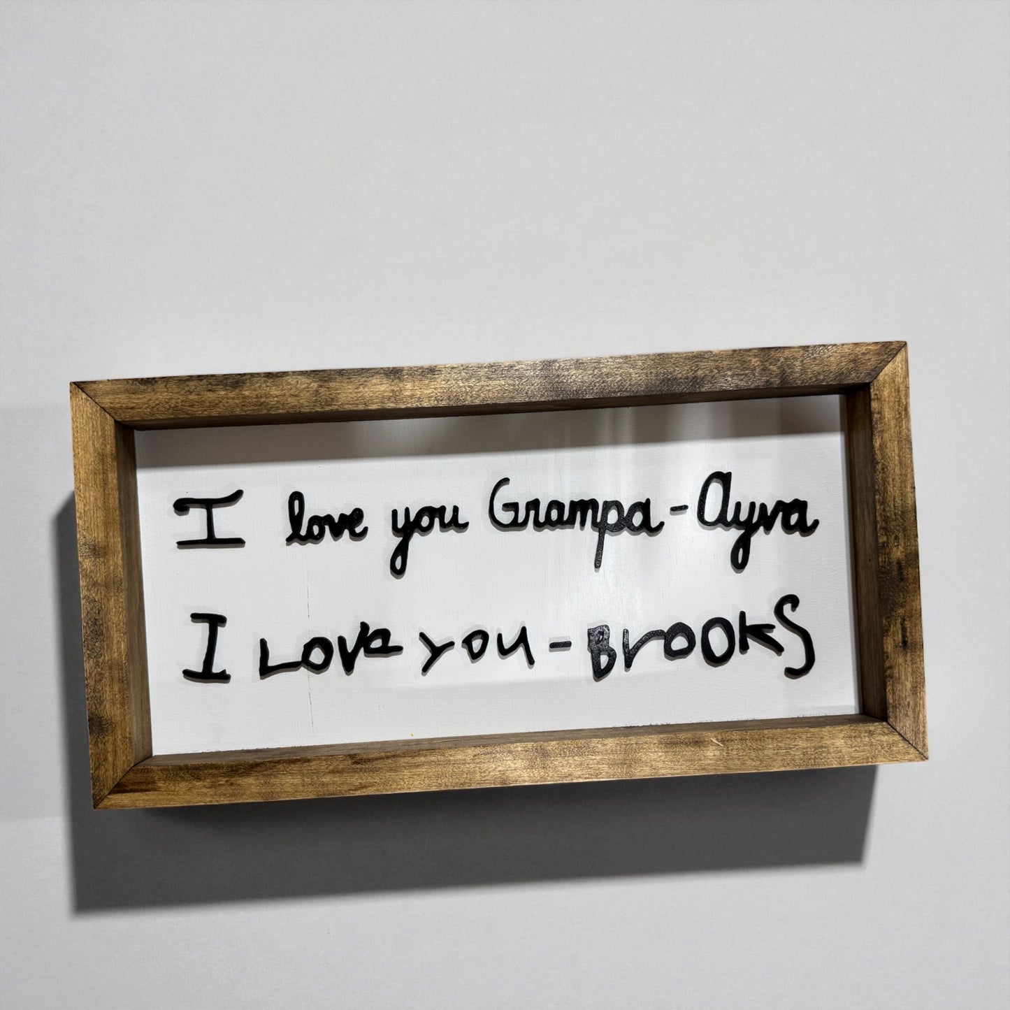 I Love You handwritten sign with dark wood frame edge and detail view