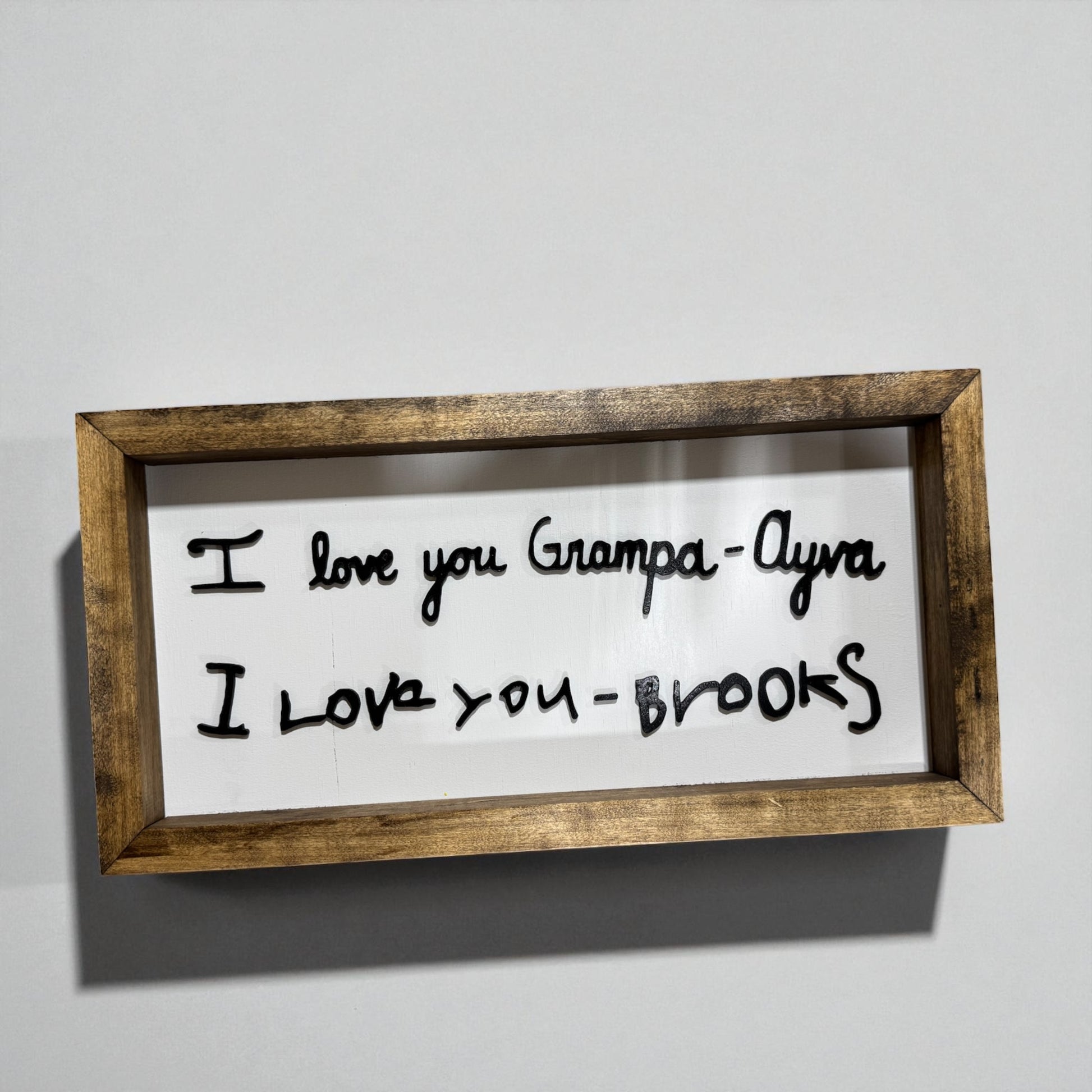 I Love You handwritten sign with dark wood frame edge and detail view