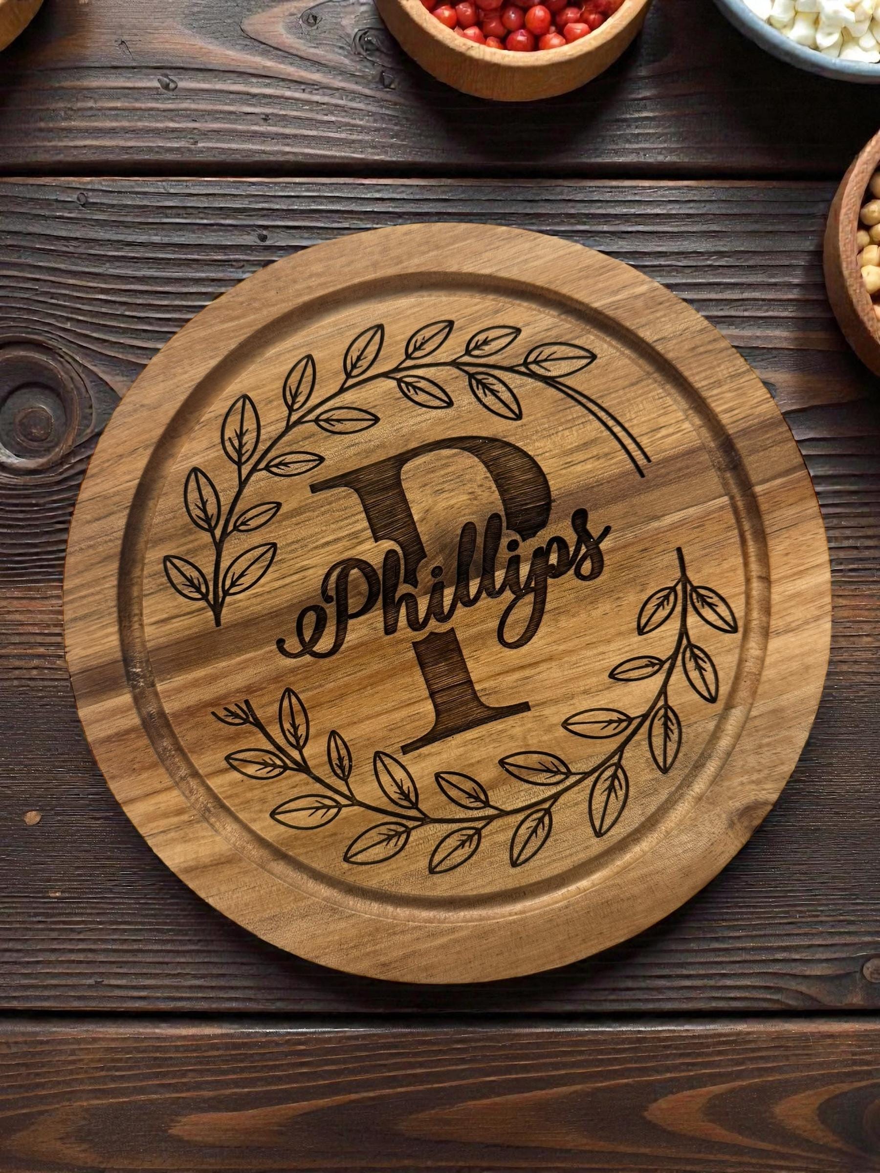 “Engraved acacia wood charcuterie board used for cheese and snacks”