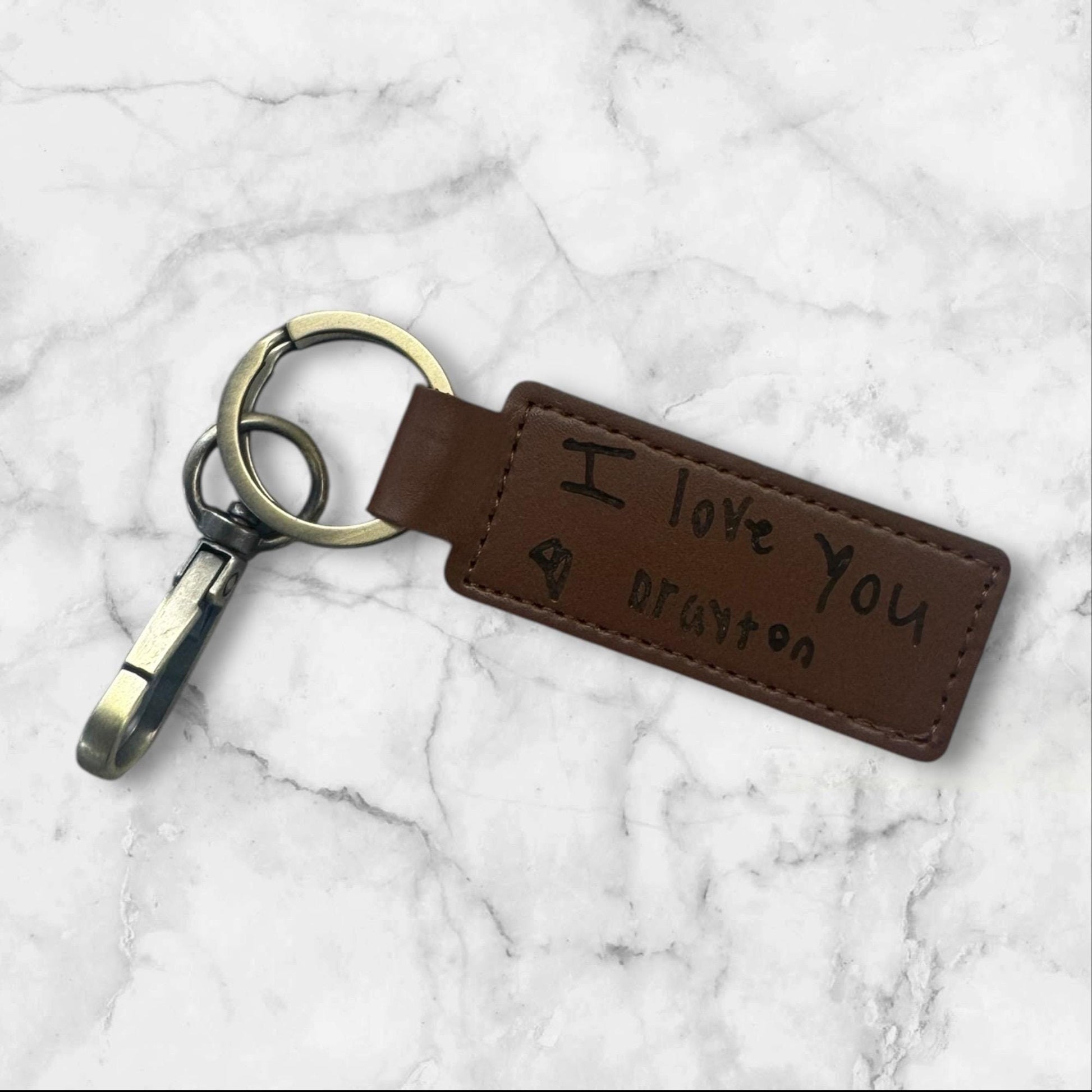 “Leather key fob engraved with child handwriting message”